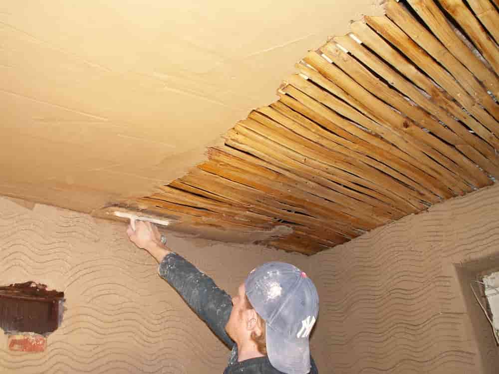 Man plastering roof