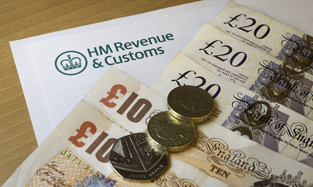Notes and coins on HMRC letter
