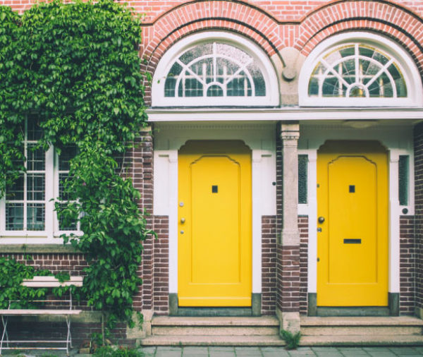 Two houses with yellow doors