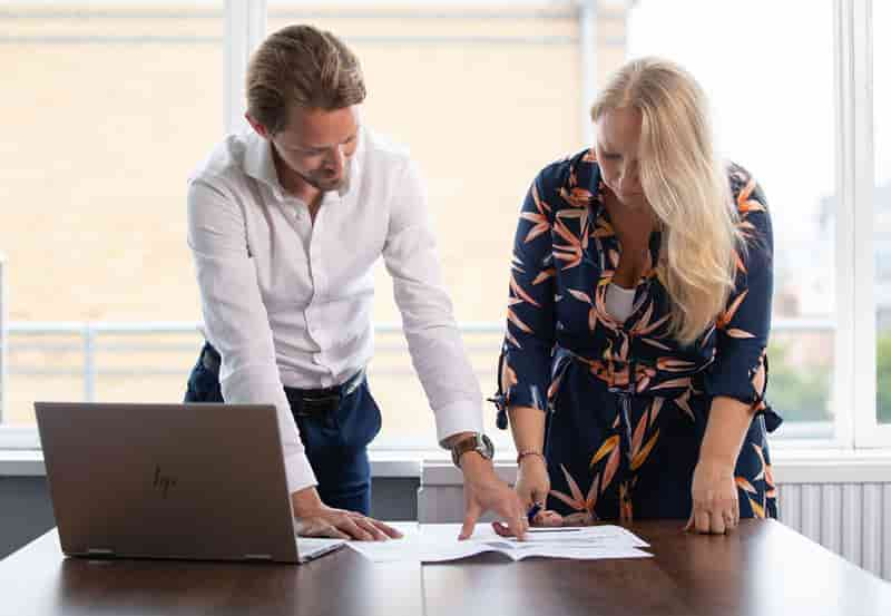 man and woman looking at a document