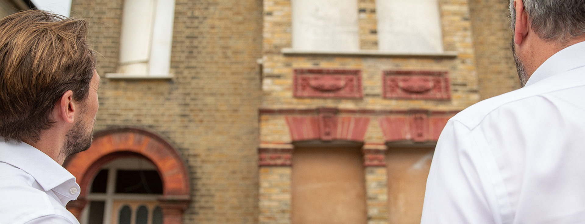 men looking at building