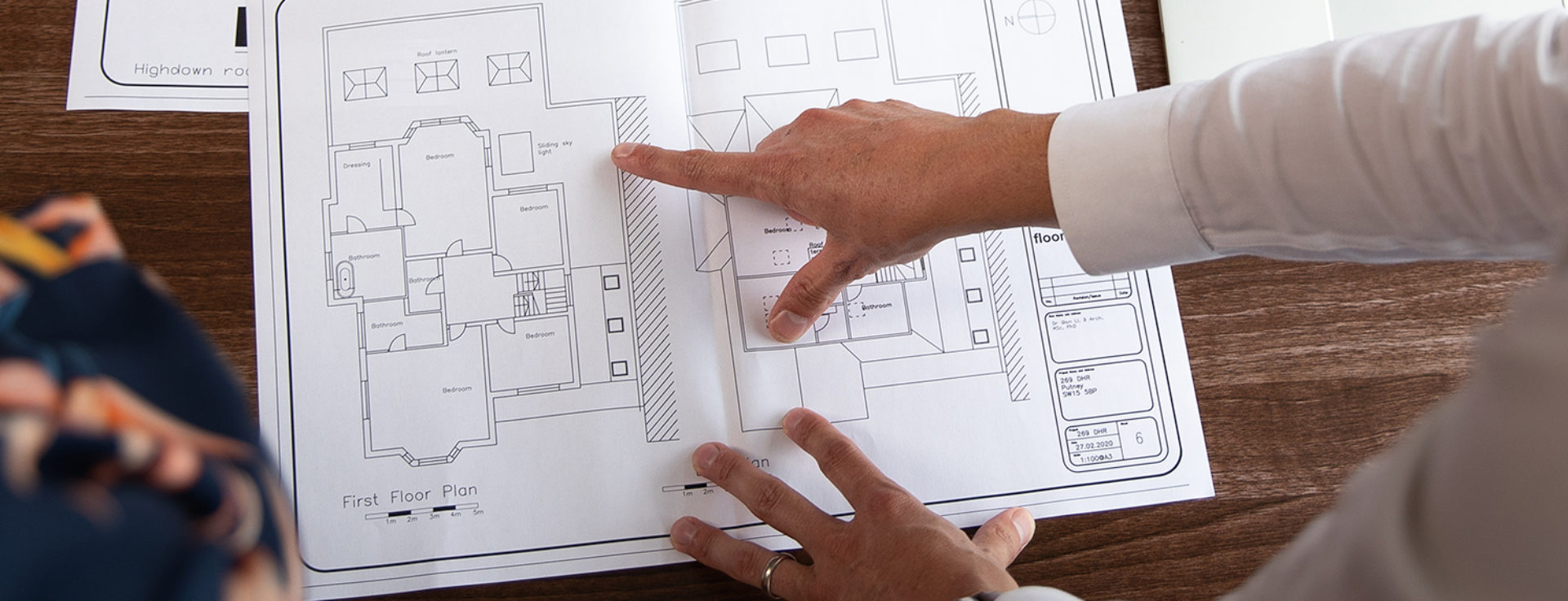 man pointing at plans