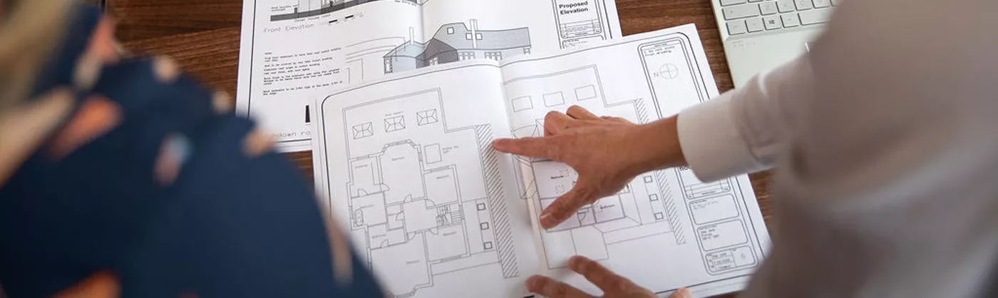 Surveyor inspecting floor plan