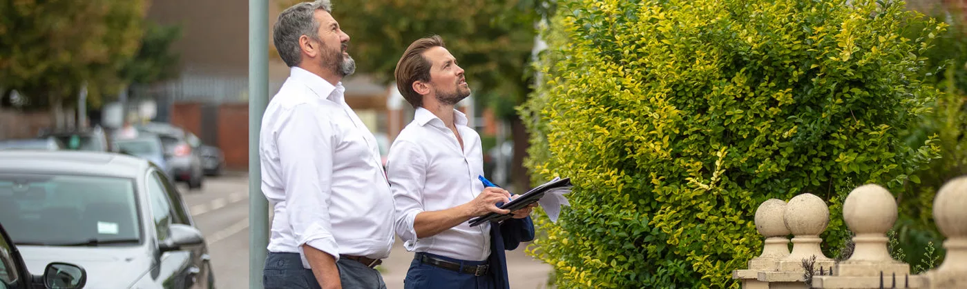 men looking at house